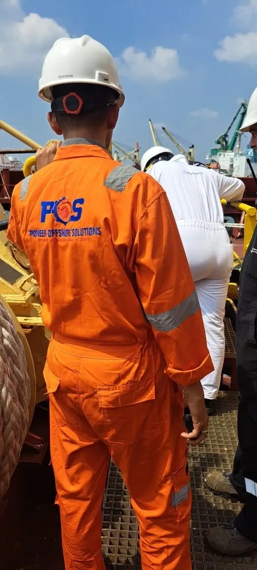 Pioneer Offshore Solutions welder in branded coveralls performing specialized welding on a vessel deck